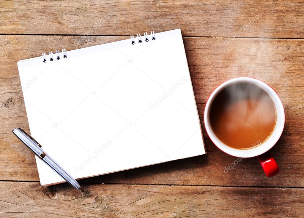 Hot coffee with note on wood background