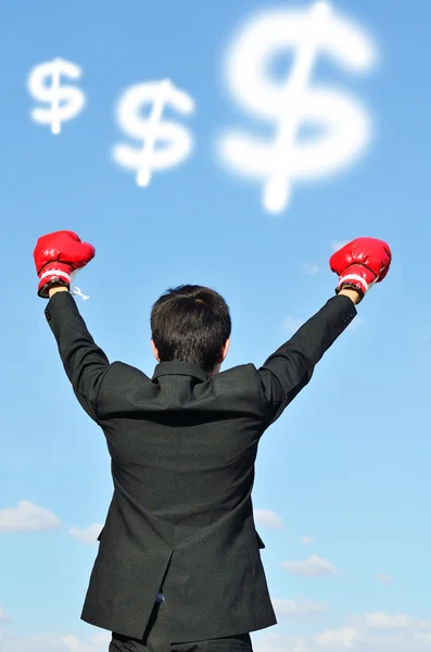 Businessman with boxing glove and dollar sign — Stock Photo, Image