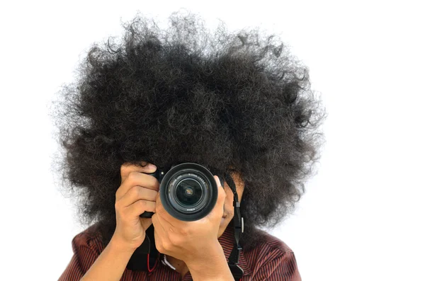 Young man with long hair and shooting camera — Stock Photo, Image