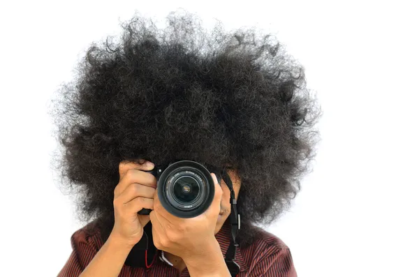 Young man with long hair and shooting camera — Stock Photo, Image