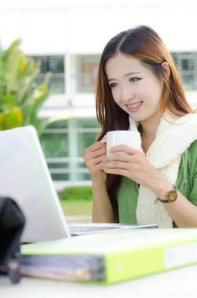 Студентки-азиатки улыбаются с чашкой кофе — стоковое фото