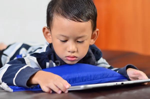 Un niño jugando un juego en la tableta de ordenador —  Fotos de Stock