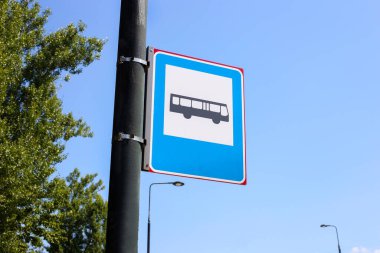 bus stop sign against the sky