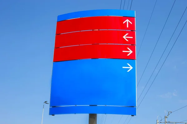 blank road sign with direction of districts. street direction sign in the middle of sky. Street sign in downtown with no inscriptions. Place for inscriptions on the direction indicator.