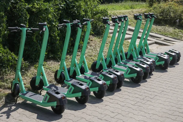 Electric scooters for public share standing outside in european city center public mobile transport, selective focus