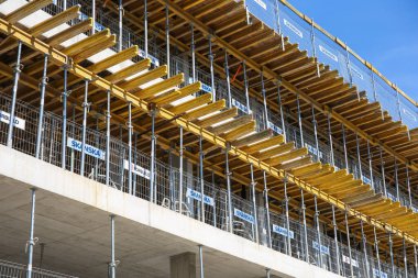 Warszaw, Poland - August, 2022: Construction site background. Hoisting cranes and new multi-storey buildings. Industrial background. Construction of a new high-rise office building, closeup view of formwork