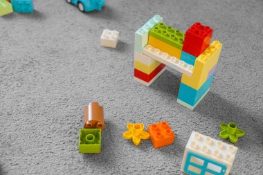 Two years old child collects constructor at home