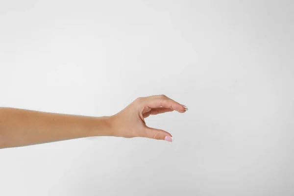 Woman hand holding two fingers showing size on a white background