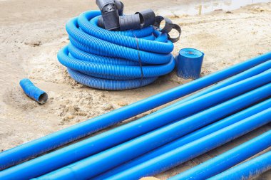 Double-walled corrugated pipes with soft broach in coilsHDPE corrugated pipe with double wall strength at the construction site. Used to protect underground cable.