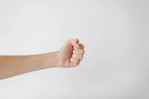 Weibliche Hand Hält Eine Faust Auf Weißem Hintergrund Stockbild