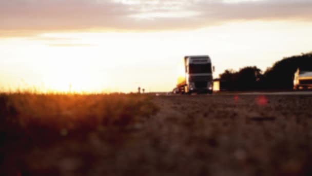 Ein LKW mit Anhänger transportiert eine Sammelladung auf der Autobahn vor dem Hintergrund des Sonnenuntergangs. Konzept der Klassifizierung von Transportgütern, Logistik, Güterumschlag, Herbst, verschwommen — Stockvideo