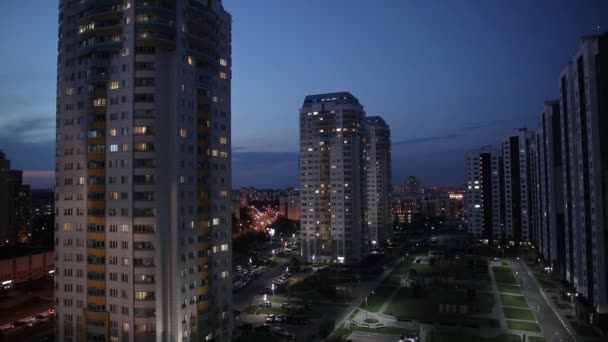 Timelapse de luces de la ciudad nocturna. Coches con faros que conducen por las carreteras. Luz en las ventanas de edificios residenciales de gran altura — Vídeos de Stock