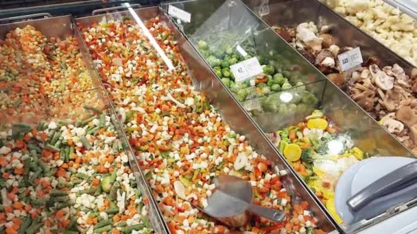 A frozen vegetable mix is sold in a grocery display store, healthy frozen food — Stock Video