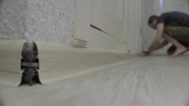 Süpürge tahtası yerleştirilirken köşeleri ayarlıyorum. Dairede tadilat var..