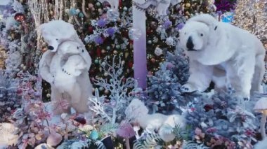 Kış çelenkleri ve aydınlatma ışıklarıyla süslenmiş Noel ağaçları. Alışveriş merkezinde kutup ayısı oyuncakları ailesi. Satış, indirim konsepti. Tatil eğlencesi. - Yakın çekim. Yeni Yıl Arifesi