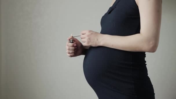 Палити дівчину з цигаркою з великим животом під час вагітності. Небезпеки та ризики для здоров'я дитини під час куріння вагітної мами. Копіювати простір для тексту — стокове відео