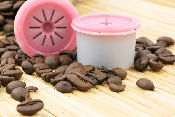 Capsules and coffee beans — Stock Photo, Image