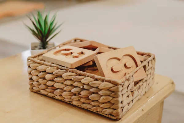 Wooden numbers in a wicker basket montessori class. High quality photo