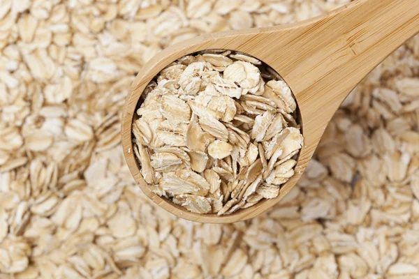 Healthy Dry Oatmeal in a wooden spoon — Stock Photo, Image