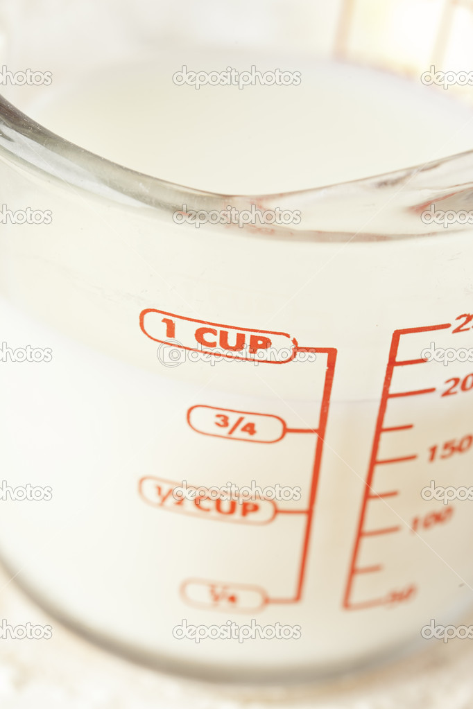 White milk in a measuring cup