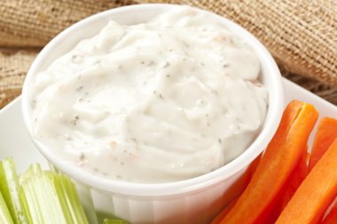 Ranch dressing with carrots and celery clipart