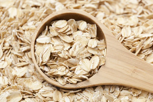 Healthy Dry Oatmeal in a wooden spoon — Stock Photo, Image