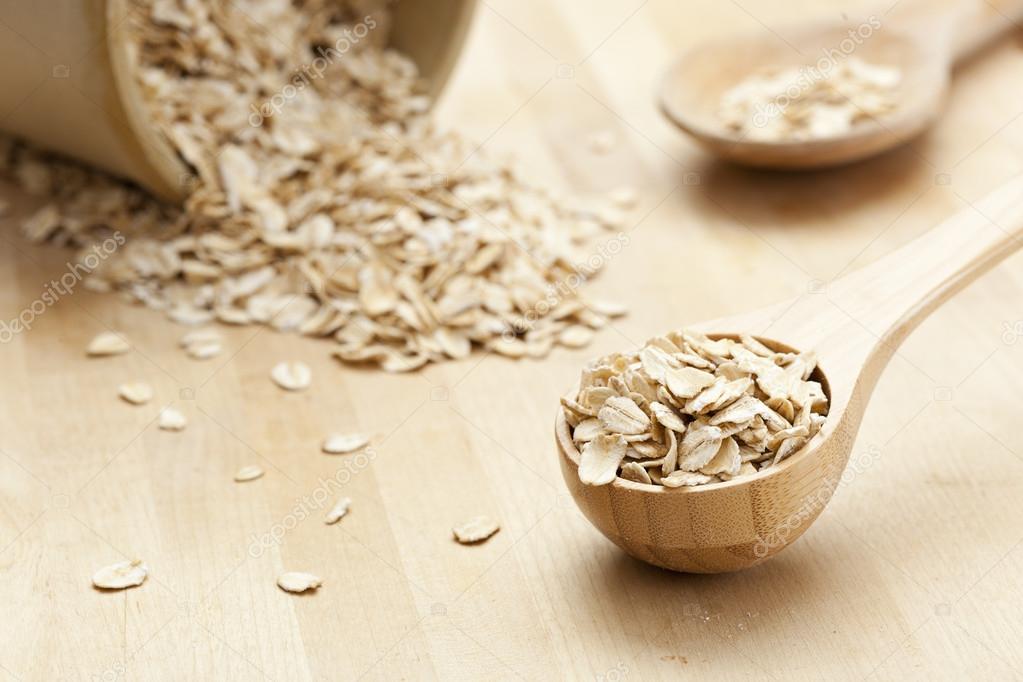 Healthy Dry Oatmeal in a wooden spoon — Stock Photo © bhofack2 20173699
