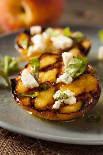 Gourmet Roasted Peaches with cheese and basil — Stock Photo, Image