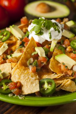 Homemade Unhealthy Nachos with Cheese and Vegetables clipart