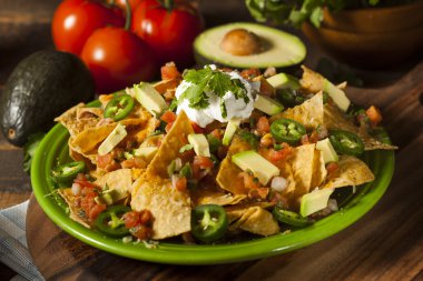 Homemade Unhealthy Nachos with Cheese and Vegetables clipart