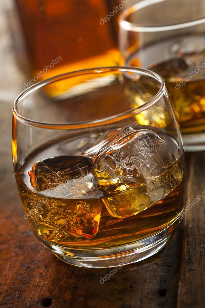 Alcoholic Whiskey Bourbon in a Glass with Ice Stock Photo by ©bhofack2  43762883