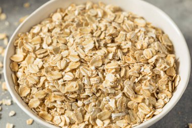 Dry Organic Rolled Oats Oatmeal in a Bowl