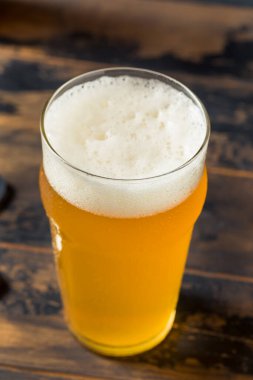 Cold Refreshing Boozy Farmhouse Ale Beer in a Pint Glass