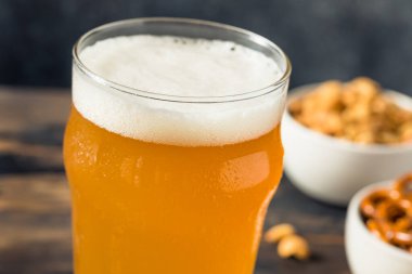 Cold Boozy Refreshing Oktoberfest Beer with Pretzels and Nuts