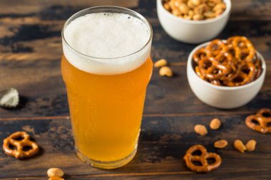 Cold Boozy Refreshing Oktoberfest Beer with Pretzels and Nuts
