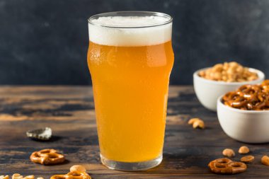 Cold Boozy Refreshing Oktoberfest Beer with Pretzels and Nuts