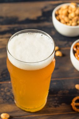 Cold Boozy Refreshing Oktoberfest Beer with Pretzels and Nuts
