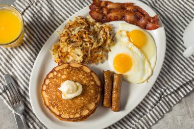 Full Homemade American Pancake Breakfast Brunch with Eggs Bacon and Hashbrowns