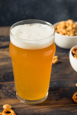Cold Boozy Refreshing Oktoberfest Beer with Pretzels and Nuts