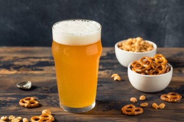 Cold Boozy Refreshing Oktoberfest Beer with Pretzels and Nuts