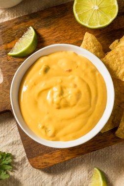 Homemade Yellow Queso Cheese Dip with Tortilla Chips and Lime