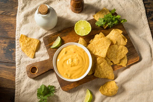 Homemade Yellow Queso Cheese Dip with Tortilla Chips and Lime