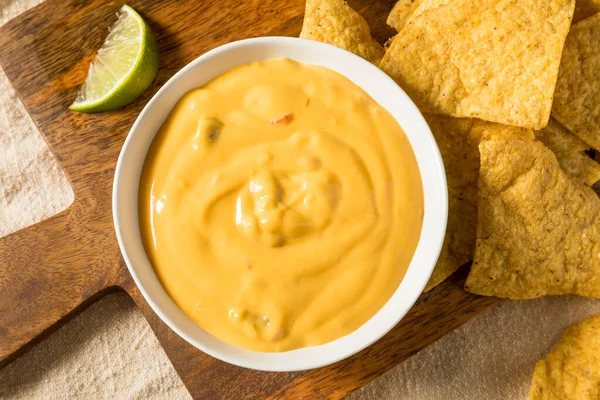 Homemade Yellow Queso Cheese Dip with Tortilla Chips and Lime