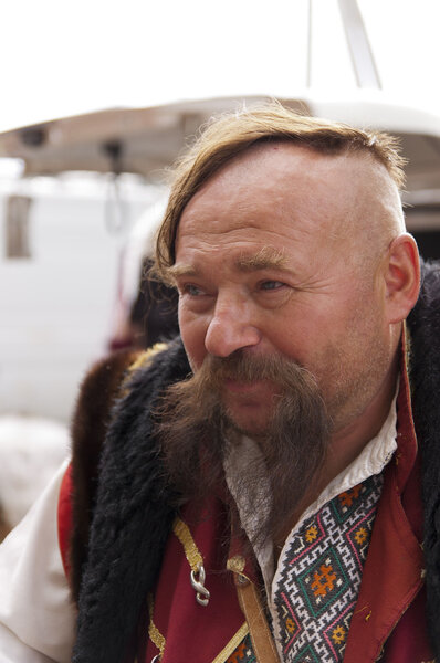 Sorochinskaya Fair. Colorful man in a suit of Zaporizhzhya Cossacks.