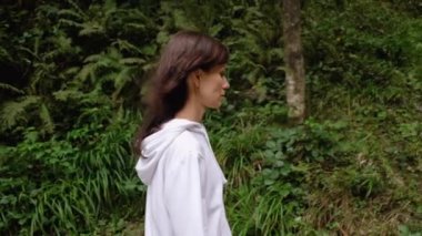 Şelaleye giden genç kadın, insanlar doğanın tadını çıkarıyor.