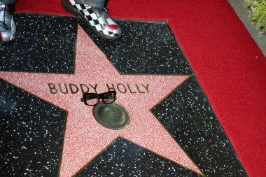Buddy Holly Star, with Gary Busey's feet and glasses clipart