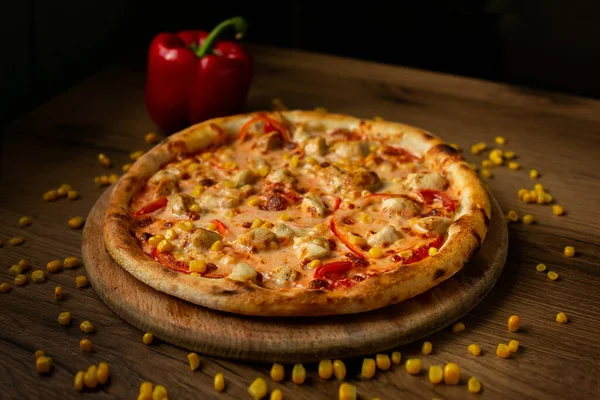 Lezzetli İtalyan pizzası ahşap masa üstü manzarasında servis edilir..