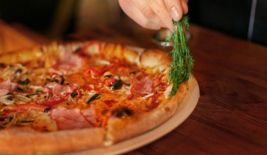 Pizzayı hazırlamak için dereotu yağı ve pizza.