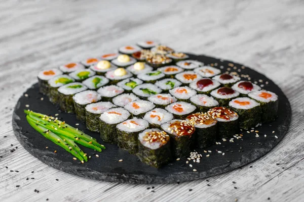Sushi roll with salmon, tuna, avocado and cucumber. Traditional japanese food. A lot of maki. Sushi rolls. top view