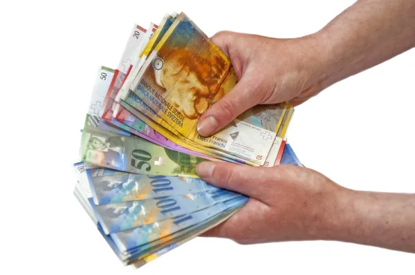 Swiss francs uang kertas memegang di tangan perempuan — Stok Foto